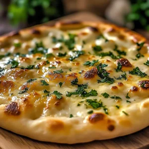 Soft garlic cottage cheese flatbread served on a rustic wooden board