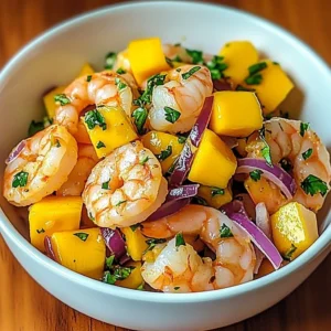 Delicious Mango Shrimp Ceviche garnished with fresh herbs and lime