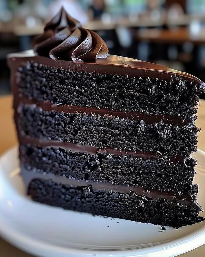 Delicious slice of Black Velvet Cake with rich frosting and dark texture