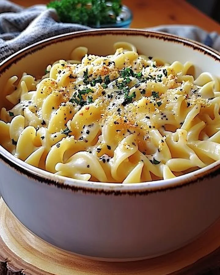 Plate of cafeteria noodles served with vegetables and sauce