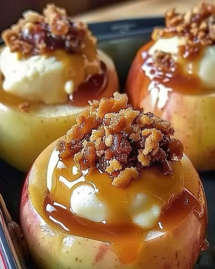Cheesecake stuffed baked apples topped with caramel drizzle