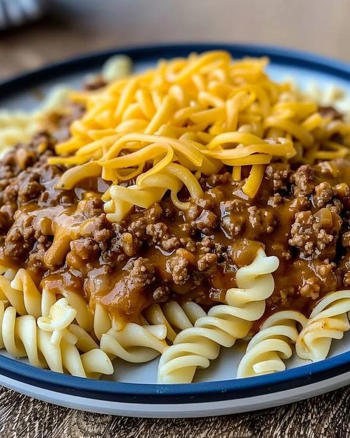 Cheesy Sloppy Cheeseburger Pasta served in a bowl with toppings.