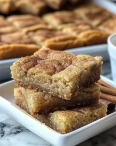 Delicious chewy snickerdoodle cookie bars topped with cinnamon sugar