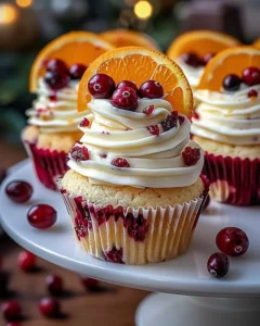 Cranberry Orange Cupcakes topped with white chocolate and fresh cranberries.