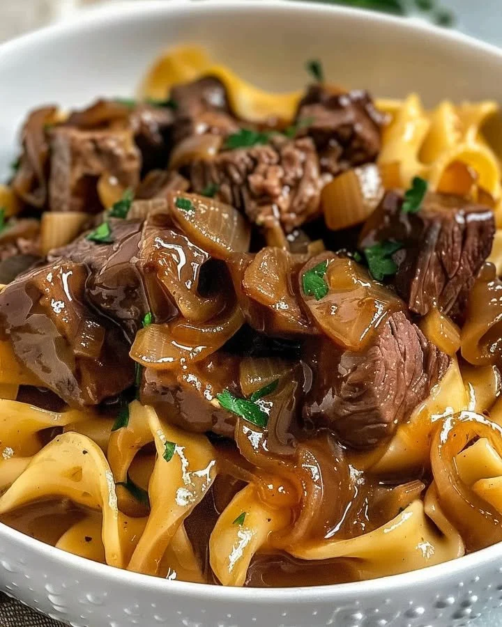 Delicious French onion beef and noodles dish with rich flavors and savory beef.