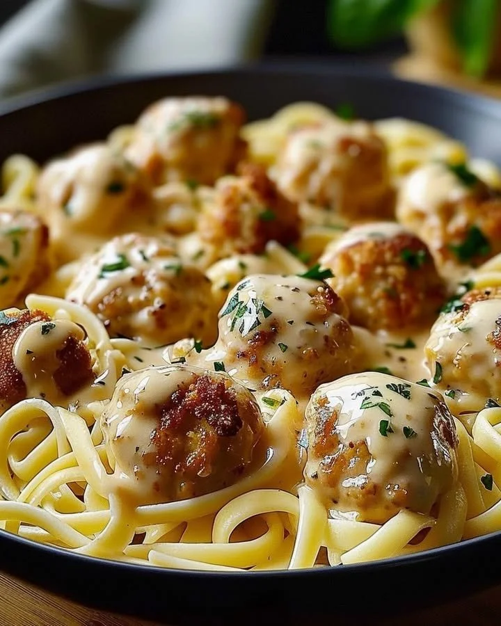 Garlic butter chicken bites served with creamy parmesan pasta on a plate