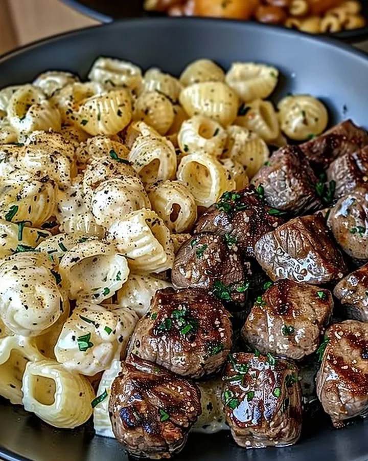 Garlic Butter Steak Bites with Creamy Parmesan Pasta Shells served on a plate