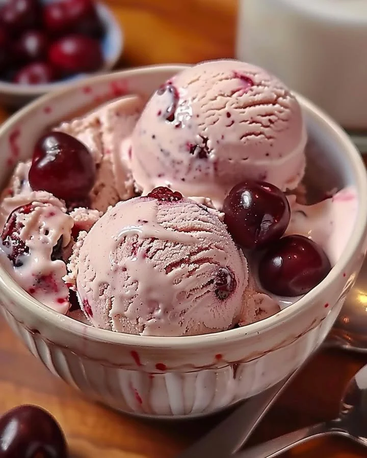 Bowl of homemade cherry vanilla ice cream topped with fresh cherries