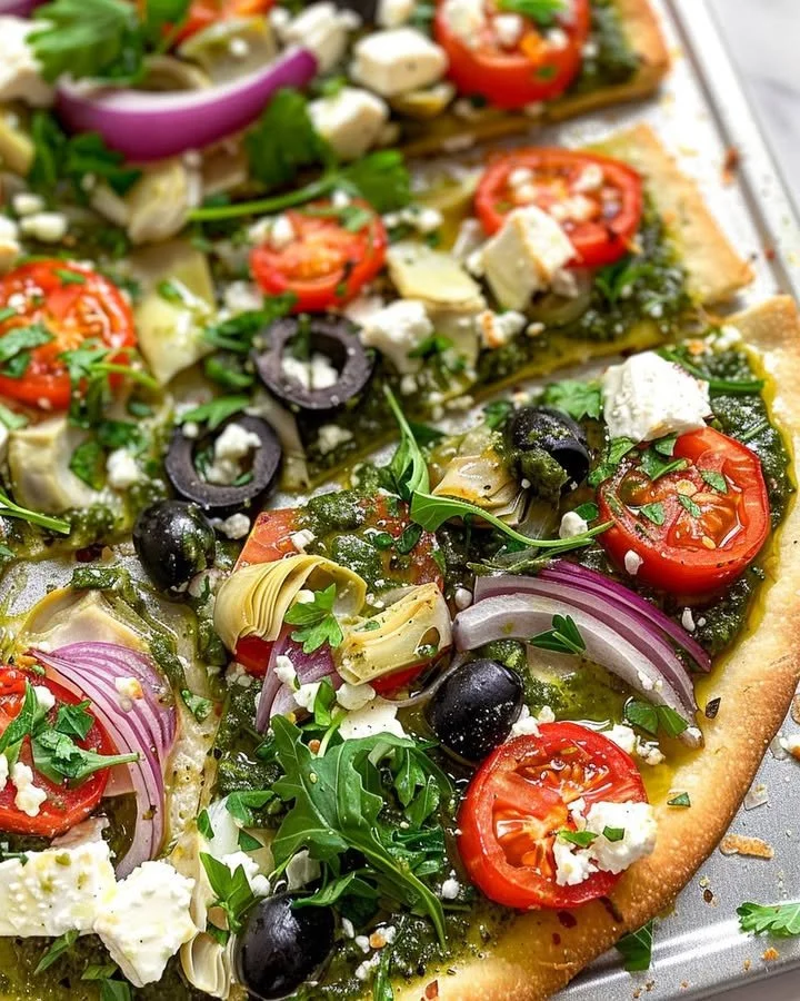 Delicious Mediterranean Veggie Flatbread topped with fresh vegetables and herbs