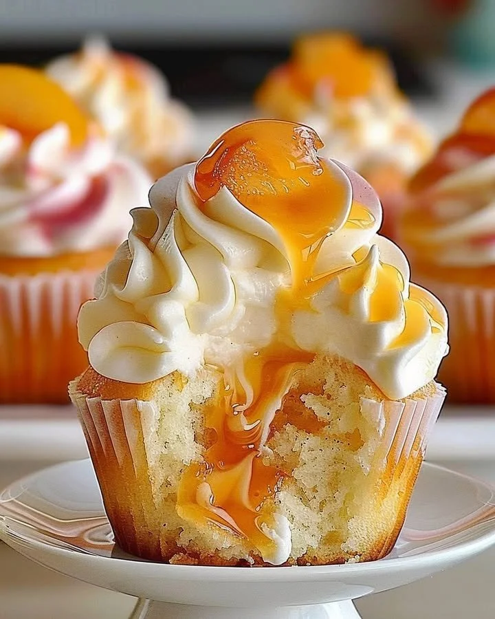 Delicious peach cupcakes with peach frosting on a decorative plate