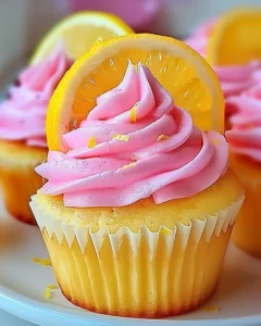 Delicious pink lemonade cupcakes topped with lemon frosting and pink sprinkles