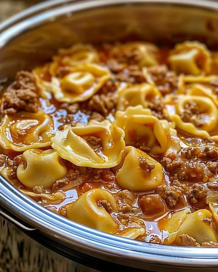 Delicious bowl of slow cooker cheesy tortellini topped with herbs