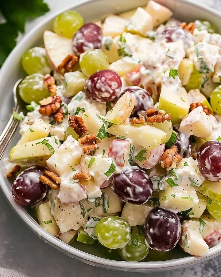 A delicious bowl of Waldorf Salad with apples, walnuts, and celery.